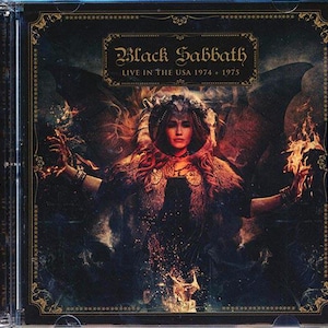 May include: CD case for Black Sabbath's "Live in the USA 1974 + 1975". The cover art features a woman with a crown and fur-lined cloak, with flames and dark imagery. The band's name is in a decorative font.