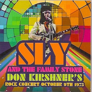 May include: A vintage concert poster featuring Sly and the Family Stone, with the text "Don Kirshner's Rock Concert October 9th 1973". The poster has a colorful, psychedelic design with a rainbow background and a large, orange "SLY" logo.