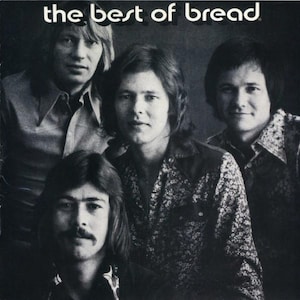 May include: Black and white photo of a band called "Bread" with four members. The band members are all wearing casual clothing and have long hair.