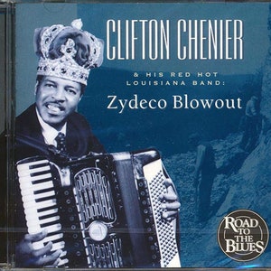 May include: A CD cover featuring Clifton Chenier & His Red Hot Louisiana Band. The cover features a photo of Clifton Chenier playing an accordion, wearing a crown and a suit. The title of the album is "Zydeco Blowout" and the album is part of the "Road to the Blues" series.