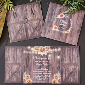 May include: Rustic wedding invitation with a woodgrain background and sunflowers. The invitation features the couple's names, wedding date, and the text "Please join us for the wedding of Delaney Jordan & Aiden Sinclair".