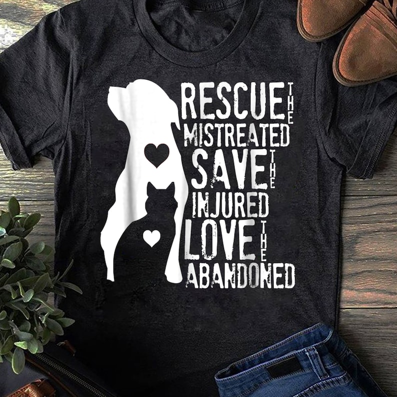 May include: A black t-shirt with a white silhouette of a dog and cat. The text "Rescue the mistreated, Save the injured, Love the abandoned" is printed on the shirt.