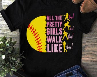 May include: Black t-shirt with a yellow softball graphic and the text "All the pretty girls walk like this!" in pink. The text is repeated four times with a silhouette of a girl playing softball next to each phrase.