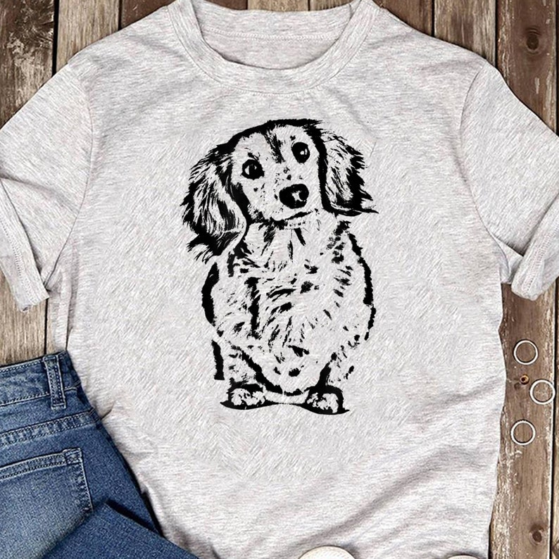 May include: A gray t-shirt with a black and white illustration of a dachshund dog.