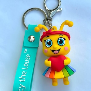 May include: A yellow cartoon character keyring with a red heart and rainbow skirt. The keyring has a teal strap with the text "Lucy the Louse" in white. The keyring is attached to a silver metal ring.