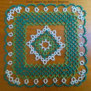 May include: A square crocheted doily with a white center and green and teal borders. The doily is on a wooden surface. "Zack's square" by Melanie Bergeron is written above the doily.