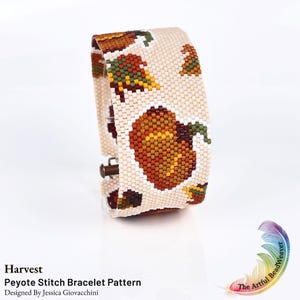 May include: A wide peyote stitch bracelet featuring a repeating pattern of orange pumpkins and multicolored autumn leaves on a cream background. The bracelet has a metallic clasp and is labeled Harvest Peyote Stitch Bracelet Pattern.
