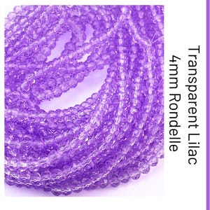 May include: A collection of transparent lilac rondelle beads arranged in a coiled strand. The beads feature a faceted surface and are labelled with the text Transparent Lilac 4mm Rondelle. Each individual bead measures 4mm in diameter.