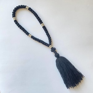 May include: Black prayer beads with silver accents and a black tassel.