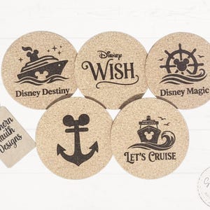 May include: Set of five round cork coasters with black Disney-themed designs. Each coaster features a different design, including a ship, anchor, and the words "Disney Destiny", "Disney Wish", "Disney Magic", and "Let's Cruise".