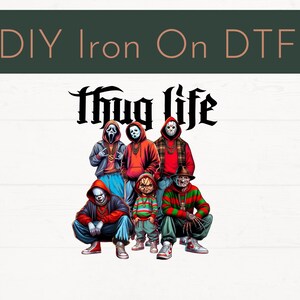 May include: DIY Iron On DTF graphic featuring a group of horror movie characters in hoodies and streetwear. The phrase "Thug Life" is written above the characters in a gothic font. The image is set against a white wood-grain background.