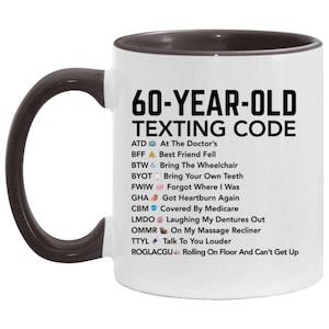 May include: White ceramic mug with a black handle and rim. The mug features the text "60-YEAR-OLD TEXTING CODE" in black, along with a list of texting acronyms and their meanings. A humorous gift idea.
