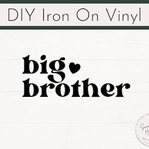 May include: Black iron-on vinyl design with the words "big brother" and a heart symbol. The text is in a bold, rounded font. The words are centered on a white background with a wood grain pattern. The top of the image has the text "DIY Iron On Vinyl".