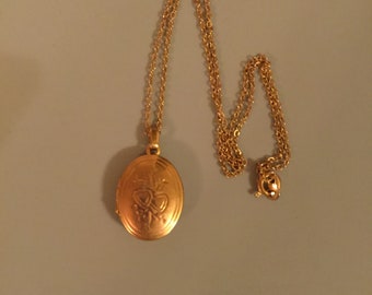 Copper Tone Locket. Has Beautiful Heart Designs. A Nice Gift to Someone Special. An Added Photo Completes this Special Piece.