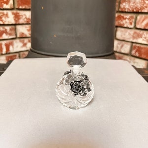 Vintage Glass Perfume Bottle. Has a Beautiful Flower Design on Both Sides. A Nice Addition to Your Collection. A Nice Gift.
