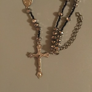 Vintage Rosary. Has Beautiful Silver Tone and Black Beads. Has a Nice Crucifix and Medal. Unique Style and Look. Great Workmanship.