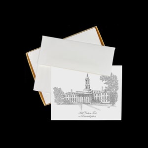 May include: A boxed set of stationery featuring a black and white line drawing of a building with a clock tower. The text "Add Custom Text or Personalization" is printed below the image.