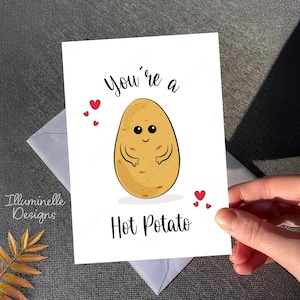 May include: A white card with a cartoon potato with a smiling face and the text "You're a Hot Potato" with red hearts.