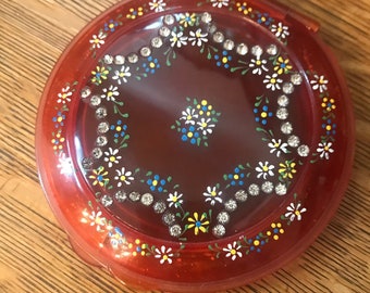 Large vintage celluloid compact incrusted with colorful rhinestones..