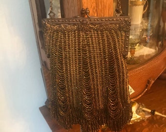 Absolutely gorgeous old  beaded purse , with copper colored glass beads with cascading fringes..