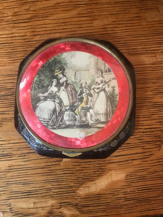 Beautiful old compact with a French scene made of 