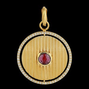 Op de afbeelding: Een gouden hanger met een cirkelvormig ontwerp. Het midden heeft een ronde, rode edelsteen, omringd door verticale lijnen. De buitenste ring is bezet met kleine, heldere edelstenen. De hanger heeft een gouden beugel om op te hangen.