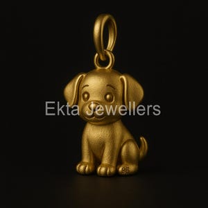 May include: A gold-colored pendant in the shape of a sitting puppy. The pendant has a loop at the top for a chain and the text "Ekta Jewellers" is visible. The number "95" is on the bottom of the pendant.