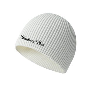 May include: A white ribbed knit beanie with the text "Christmas Vibes" in black script. The hat is a winter accessory, perfect for staying warm during the holiday season. The beanie is a neutral color, making it versatile for various outfits.