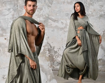 May include: Two people wearing loose-fitting, flowing, gray clothing. The person on the left is wearing a long, draped garment with a cowl neck. The person on the right is wearing a long, flowing dress with a wrap-style top.
