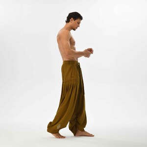 Earthy brown boho pants for men, designed with a harem cut and comfy cotton fabric, perfect for festivals and casual wear.