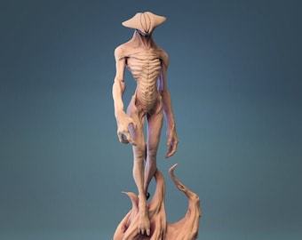 May include: A detailed, beige-colored, 3D printed figurine of a humanoid creature with a large, flat head and a flowing, abstract base.
