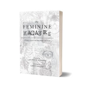 May include: A hardcover book titled "The Feminine Macabre" with a white and gray cover featuring illustrations of a skeleton, eye, and floral elements. The book is curated by Amanda R. Woomer and foreword by Loren Rhoads.