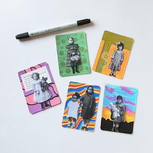 May include: A collection of six vintage-style art cards featuring images of children. Each card has a unique colorful border and a black and white photograph. A black marker with the text "ARTISTRO" is also present.