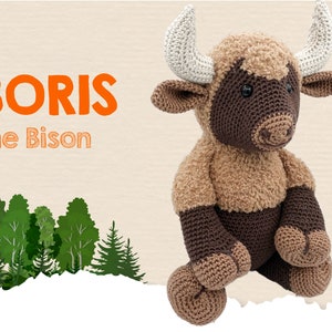 May include: Boris the Bison is a crocheted stuffed animal with brown and tan fur. He has a brown nose, black eyes, and white horns. He is sitting on a white background with a green forest behind him.