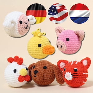 May include: A collection of seven crocheted animal heads: a sheep, duck, pig, chicken, dog, and tiger. The sheep is white and pink, the duck is yellow and orange, the pig is pink, the chicken is white and red, the dog is brown, and the tiger is orange and white.