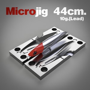 May include: A silver and red Microjig fishing lure, 44cm long, resting on a metal mold. The lure has a red head and a silver body. The text "Microjig 44cm. 10g.(Lead)" is displayed in red and white.
