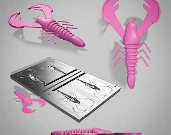 May include: A set of pink plastic molds for making fishing lures. The molds are designed to create a crawfish shape with segmented body and claws. The molds are shown with a finished lure.