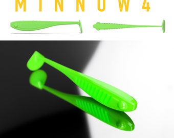 Puede incluir: Un señuelo de pesca de plástico blando de color verde brillante de 10 cm de largo con forma de pez pequeño. El señuelo tiene un cuerpo acanalado y una cola de paleta.