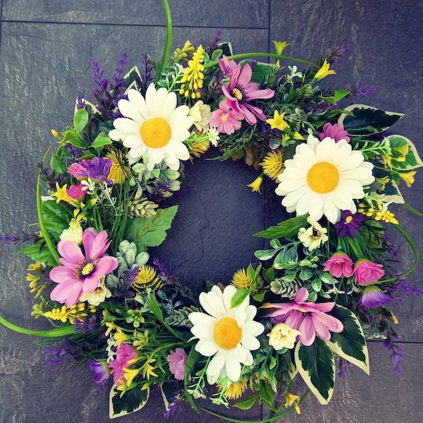 Summer wreath with anemone, daisies and green, yellow, purple foliage