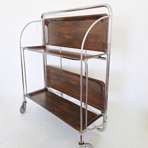 Vintage Duitse serveerwagen Dinett, jaren 60 en 70 opvouwbare barwagen GERLINOL in donkerbruin, MCM verchroomde bijzettafel op wielen