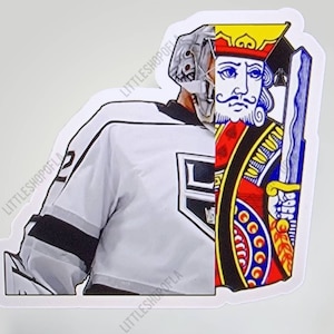 May include: A sticker featuring a split design: a hockey goalie in a white jersey with black accents and a King playing card. The King card is red, black, and blue with a gold sword. The text "LITTLESHOPOFLA" is repeated around the sticker.