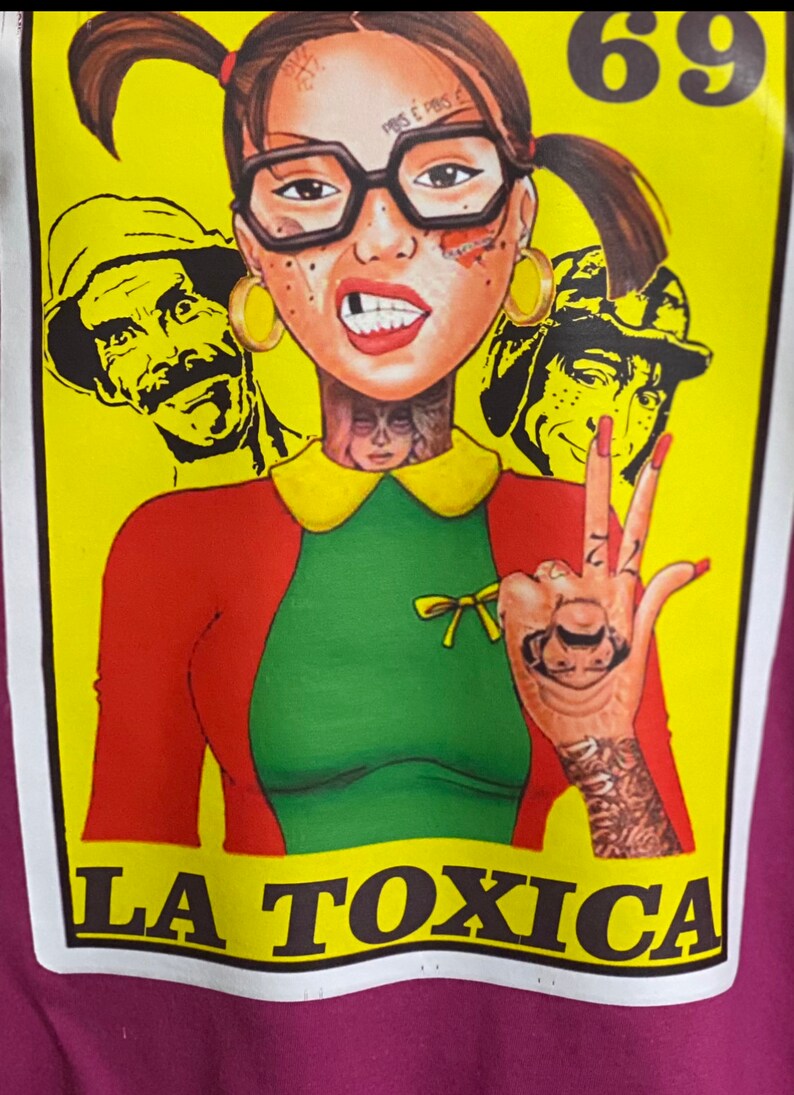 May include: A yellow and red illustration of a girl with pigtails wearing a green and red dress and glasses. She has a tattoo on her neck and a tattoo of a face on her hand. The text "LA TOXICA" is printed below the girl. The number "69" is printed in the top right corner of the image.