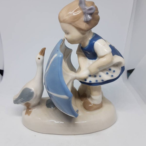 Carl Schneider: vintage porcelain figurin "Girl fighting off goose with umbrella ". 1950s.