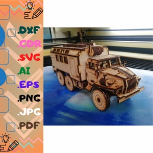 May include: A wooden model of a military truck with six wheels, constructed from light brown wood. The model features detailed cutouts and a realistic design, including a cab, cargo area, and various exterior components. The image also includes a list of file formats.