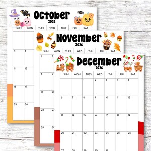May include: A stack of three seasonal 2026 calendars. The October calendar features Halloween-themed graphics, the November calendar has fall-themed graphics, and the December calendar has Christmas-themed graphics.