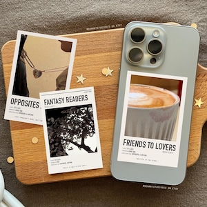 Może przedstawiać: Trzy drukowane wzory na etui do telefonu z tekstem "Opposites", "Fantasy Readers" i "Friends to Lovers". Każdy wz&oacute;r zawiera inny obrazek: parę, drzewo i filiżankę kawy.