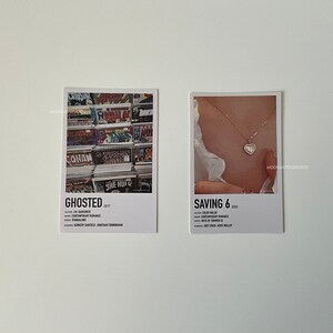 May include: Two minimalist movie poster prints with white borders. The left poster features a photo of a wall of comic books and the title "GHOSTED 2017". The right poster features a photo of a person wearing a necklace with a heart pendant and the title "SAVING 6 2023".