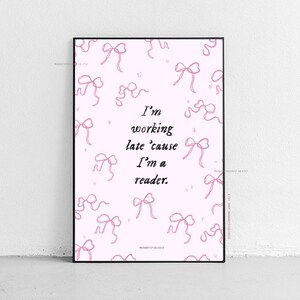 Op de afbeelding: Een roze en witte printbare poster met een quote die luidt "Ik werk laat omdat ik een lezer ben." De achtergrond is gevuld met een patroon van roze strikken.