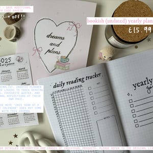 May include: A pink and white undated yearly planner with a heart design and the text "dreams and plans". The planner includes a daily reading tracker, a yearly goals section, and a year at a glance calendar. The planner is priced at &euro;15.99.