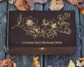 May include: A dark brown wooden box with a gold floral design and the text "CUSTOM TEXT OR NAME HERE". The box has a gold clasp and is surrounded by autumn leaves.